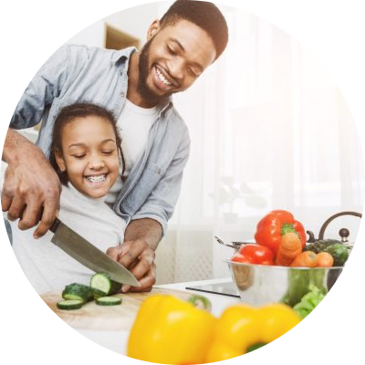 father with kid training kid how to cook vegan food father with kid training kid how to cook vegan food